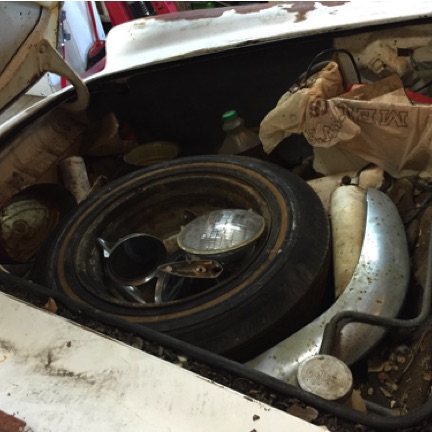 Original trunk with battery compartment covered by plastic Walmart bag